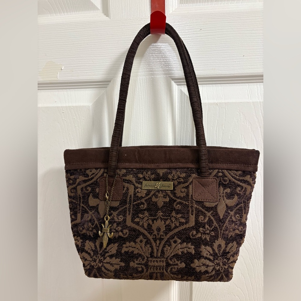 Isabella's Journey petite carpet bag with a brown fleur-de-lis tapestry pattern.